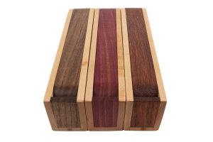 A wooden box with three different colors of wood.