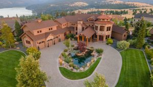 An aerial view of a large mansion in the mountains.