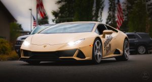 A lamborghini huracan parked in front of an american flag.