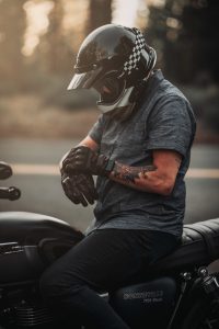 A man sitting on a motorcycle wearing a helmet.