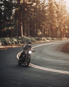 A person riding a motorcycle down a curvy road.