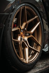 A close up of a car with a gold rim.