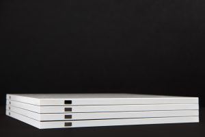 A stack of white books on a black background.