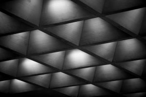 A black and white photo of a concrete ceiling.