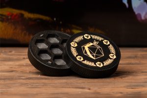 A black and gold grinder on a wooden table.