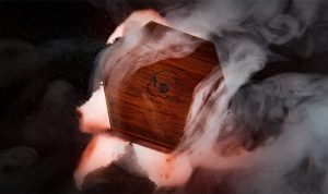 A wooden coffin with smoke coming out of it.