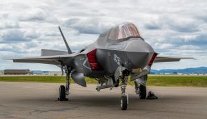 An f-35 fighter jet is parked on a runway.