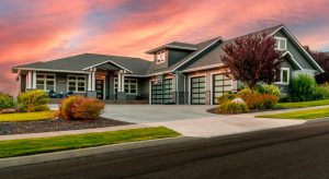 A home with a driveway and garage at sunset.