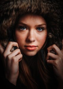 A woman in a fur hat posing for a photo.
