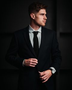 A man in a suit is posing for a photo.