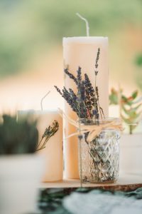 Lavender candles on a wooden table.